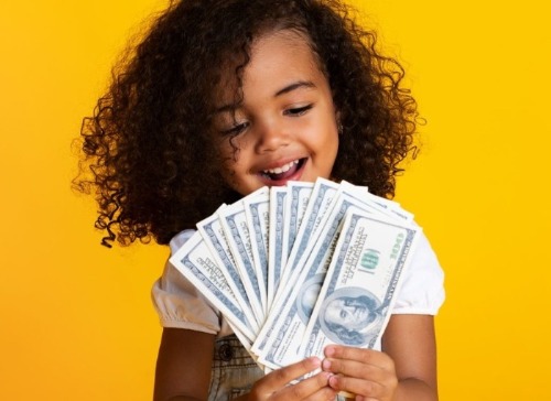 Young girl holding cash