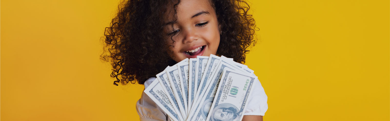 Young girl holding lots of cash