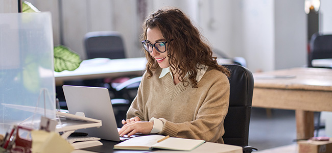 ATFCU | Online Banking Platform | Woman sitting at her computer