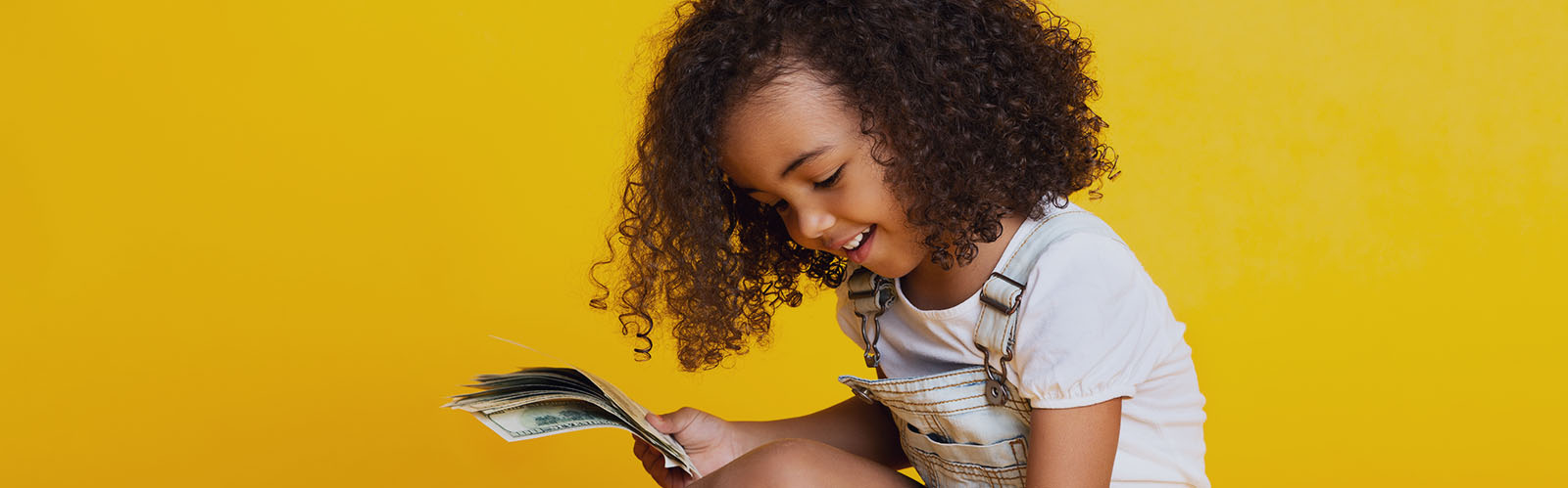 Young girl looking at cash