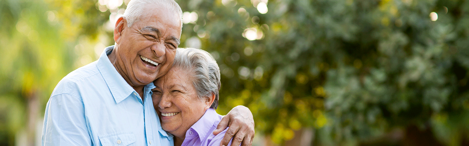 older couple smiling and hugging eachother