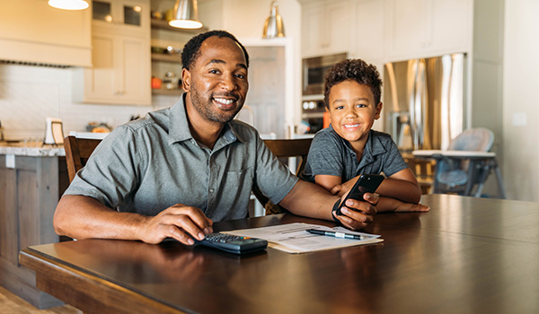 Setting up a True Youth Account, father and son at a table.