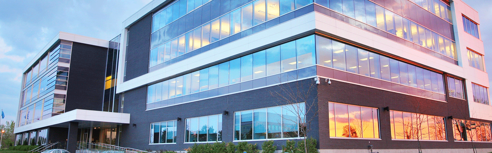 large commercial building with windows at sunset