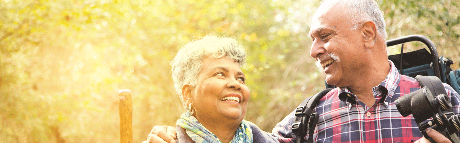 two people hiking and smiling at each other