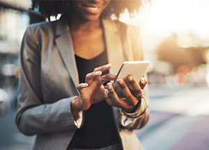 woman using phone while smiling