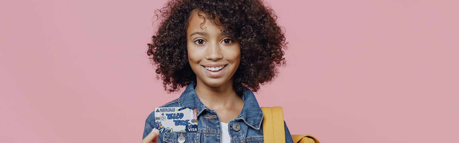 Young girl holding the True Youth Debit Card