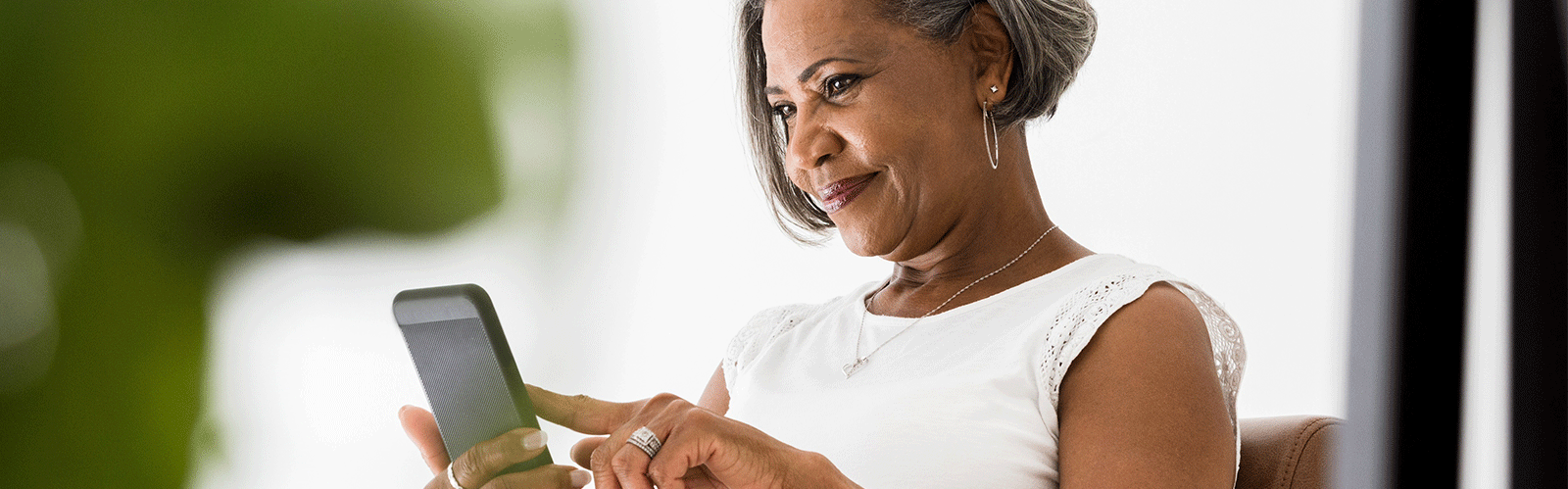 woman using her phone's touch screen