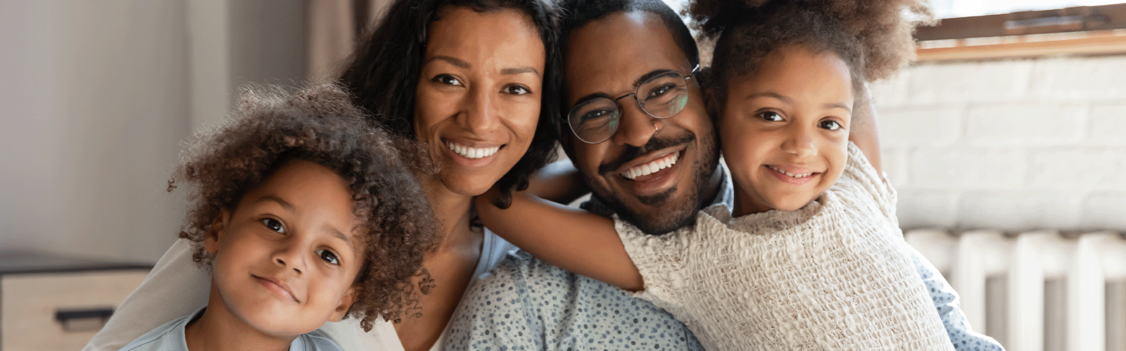 family smiling at camera