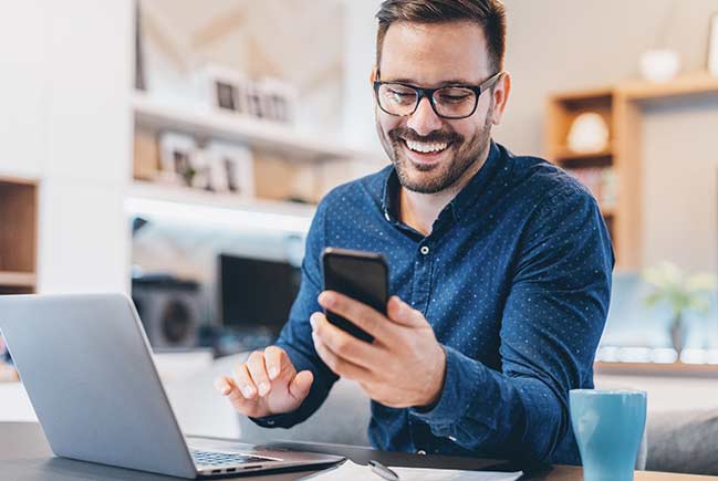 Person looking at phone and smiling