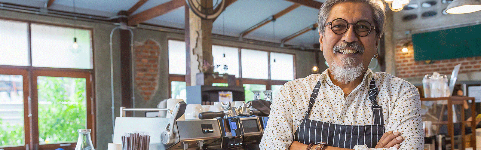 older business owner smiling at camera