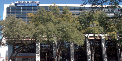 Large Austin Telco building with trees in front.